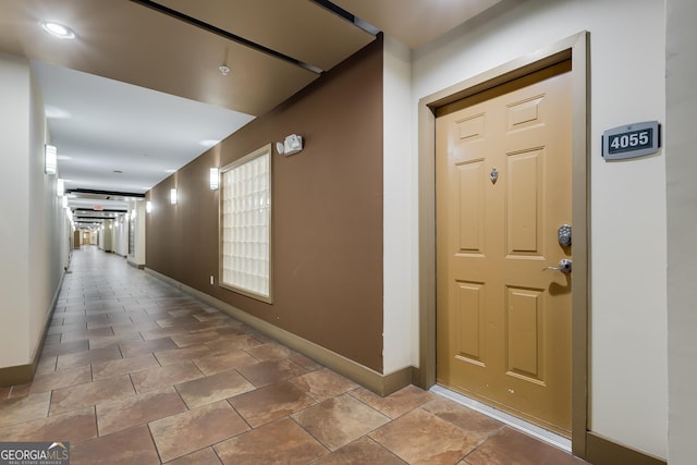 corridor featuring baseboards
