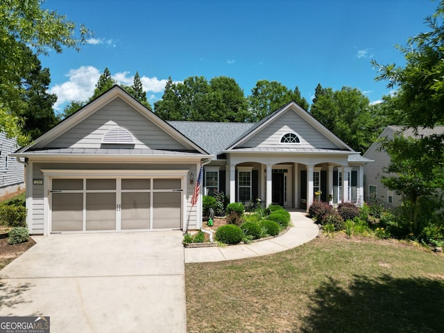 230 Begonia Ct, Griffin, GA 30223 - greek revival house featuring a standing seam roof, concrete driveway, an attached garage, covered porch, and a front lawn