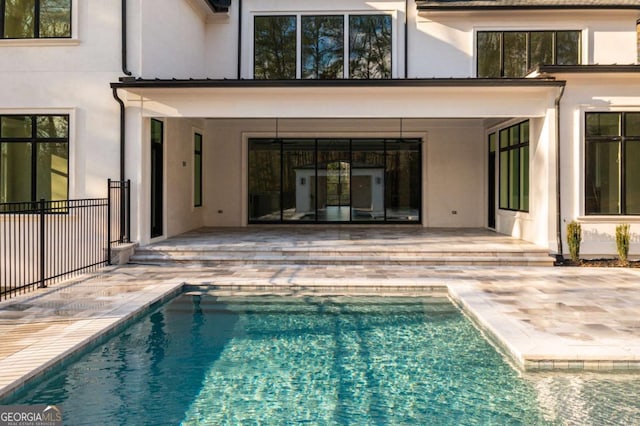 5211 Powers Ferry Rd, Sandy Springs, GA 30327 - rear view of house with a patio, stucco siding, and an outdoor pool