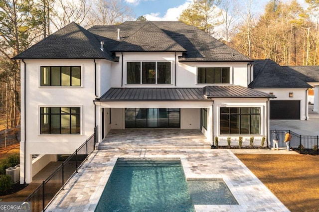 5211 Powers Ferry Rd, Sandy Springs, GA 30327 - rear view of house featuring stucco siding, a patio area, a shingled roof, and a standing seam roof