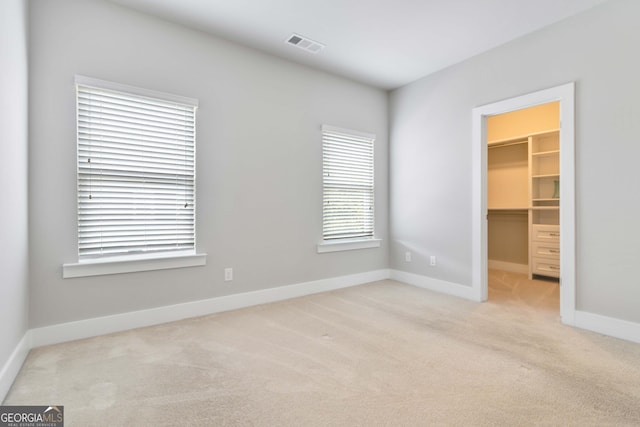 1405 Attwater Dr, Atlanta, GA 30316 - unfurnished bedroom featuring carpet flooring, a walk in closet, baseboards, and a closet