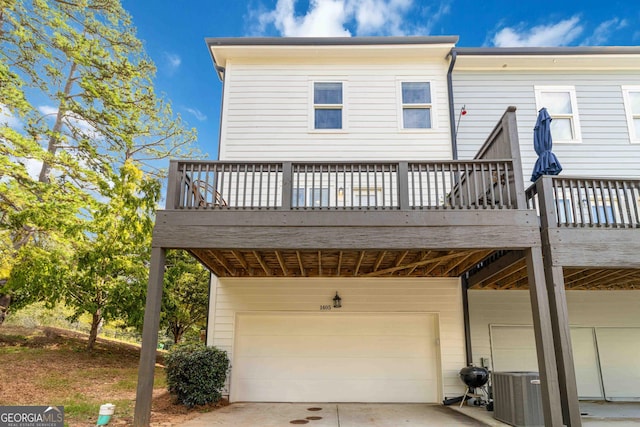 1405 Attwater Dr, Atlanta, GA 30316 - back of property featuring a garage, a deck, central AC, and concrete driveway