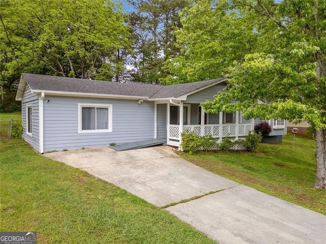 view of front of home with covered porch, a front yard, driveway, and roof with shingles