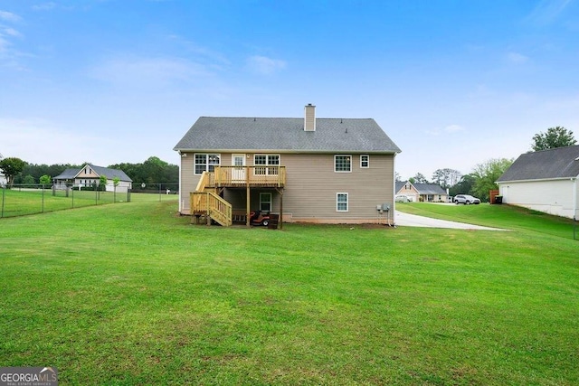 back of property with stairway, a wooden deck, and a chimney