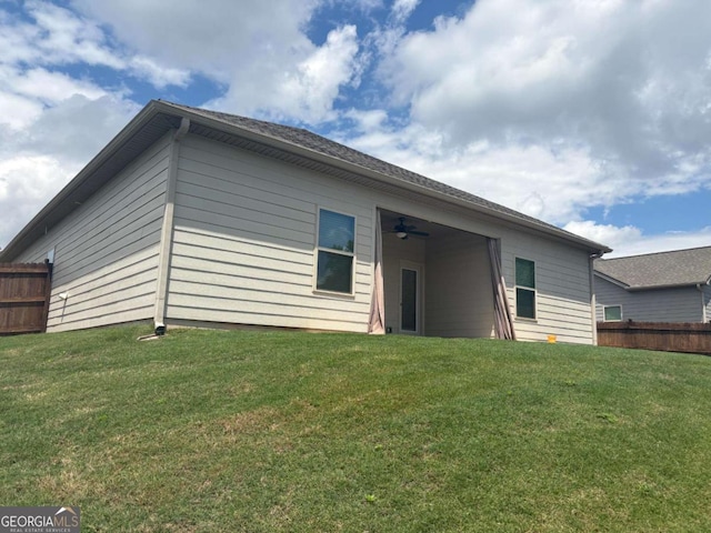 back of property featuring a ceiling fan