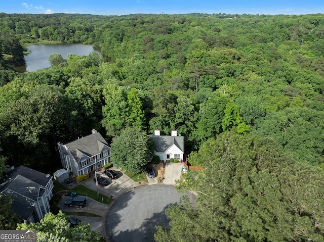 aerial overview of property's location featuring a heavily wooded area and a large body of water