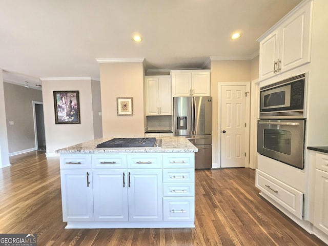 kitchen with stainless steel appliances, ornamental molding, a center island, dark wood-style floors, and white cabinets