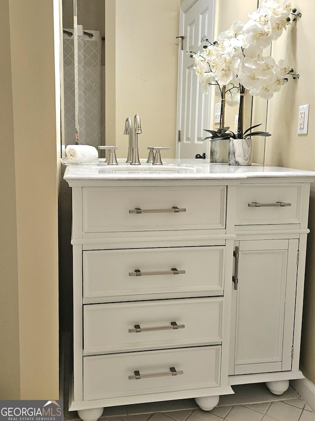 full bathroom with vanity and tile patterned flooring