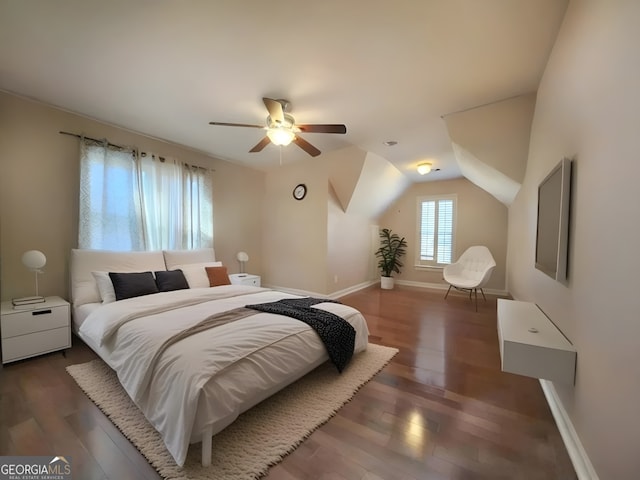 bedroom with baseboards, wood finished floors, ceiling fan, and vaulted ceiling