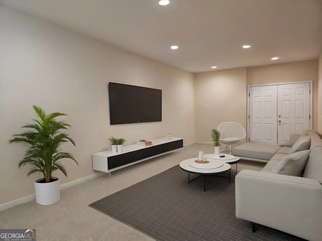 carpeted living area featuring recessed lighting and baseboards