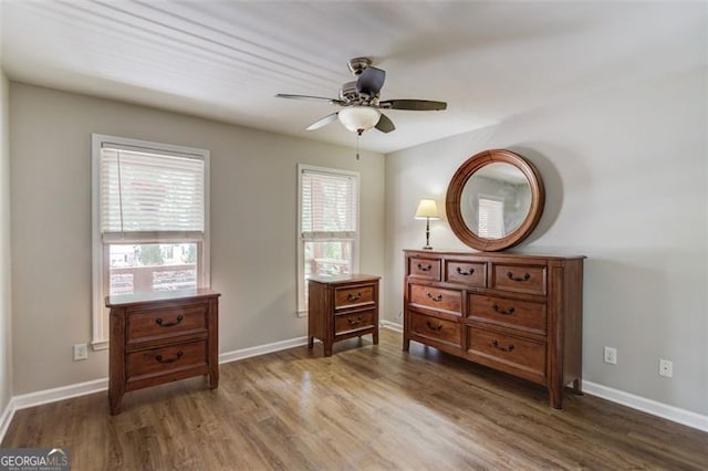bedroom with wood finished floors, baseboards, and ceiling fan