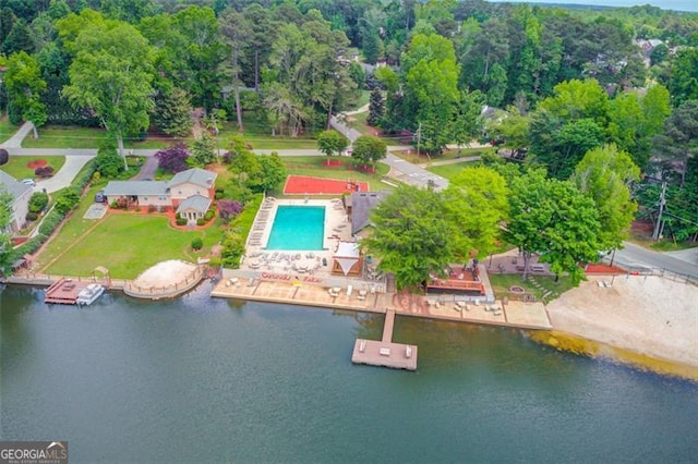 bird's eye view of a pool and a nearby body of water