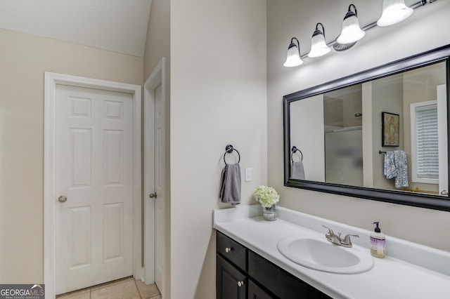 full bath featuring vanity, tile patterned floors, and a shower