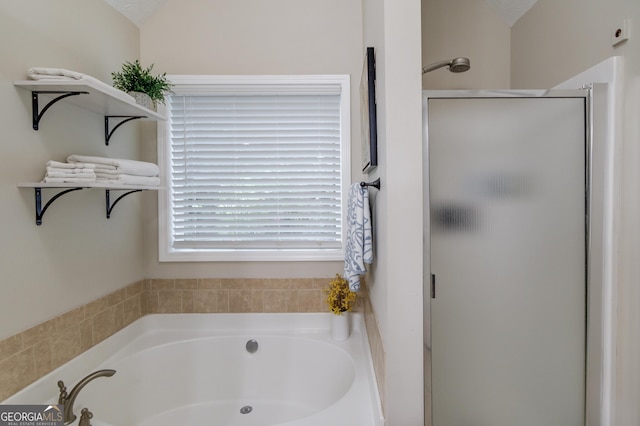 bathroom with a bath and a shower stall