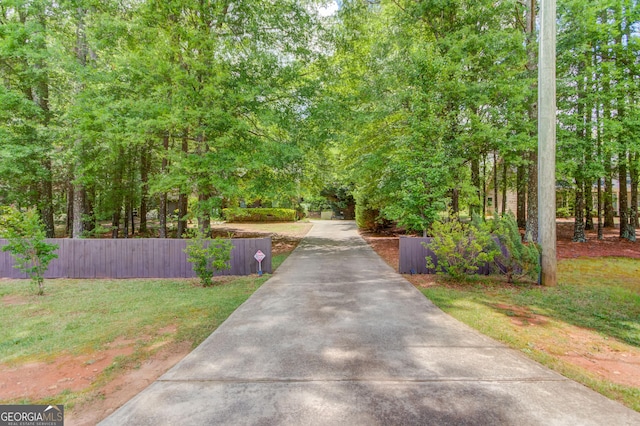 view of property's community with concrete driveway