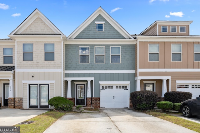 2656 Avanti Way, Decatur, GA 30035 - view of property with board and batten siding, concrete driveway, and a garage