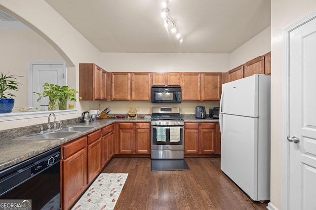 2656 Avanti Way, Decatur, GA 30035 - kitchen with black appliances, a sink, dark wood-style floors, brown cabinetry, and arched walkways