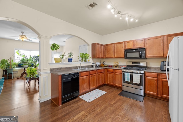 2656 Avanti Way, Decatur, GA 30035 - kitchen featuring black appliances, arched walkways, a sink, dark wood-style floors, and brown cabinets