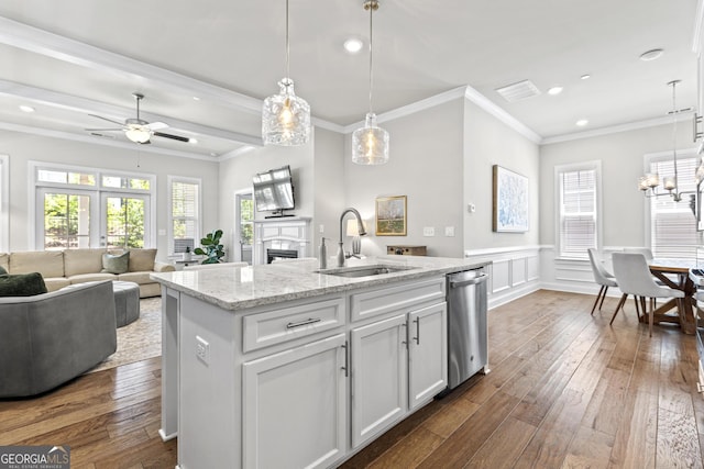 kitchen featuring stainless steel dishwasher, a sink, crown molding, dark wood-style floors, and recessed lighting