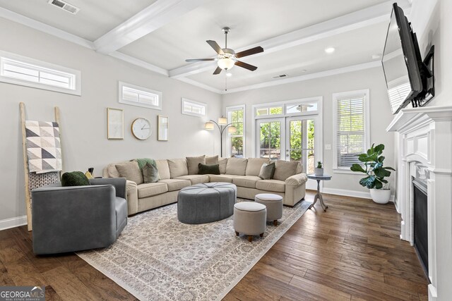 living room with a ceiling fan, a fireplace, healthy amount of natural light, baseboards, and beamed ceiling
