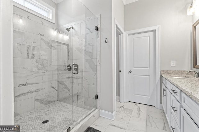 full bath featuring marble look tile flooring, a shower stall, baseboards, and vanity