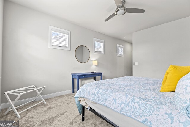 bedroom featuring carpet floors, baseboards, and a ceiling fan