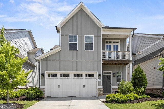 craftsman inspired home featuring board and batten siding, driveway, and a balcony