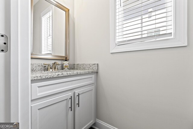 bathroom with vanity and baseboards