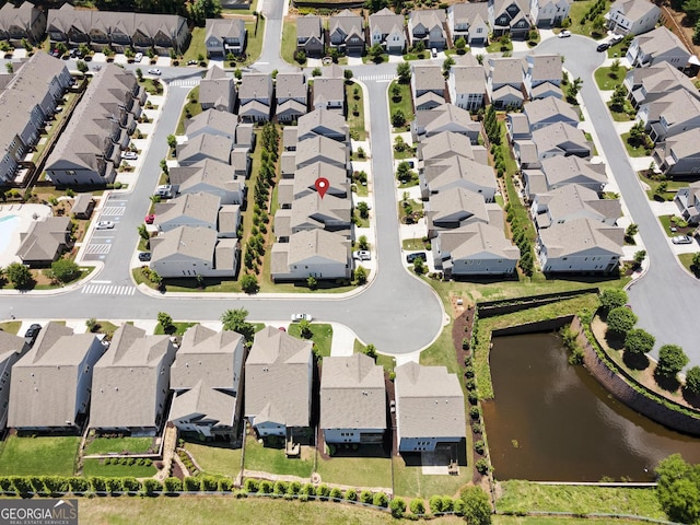 aerial perspective of suburban area with a nearby body of water