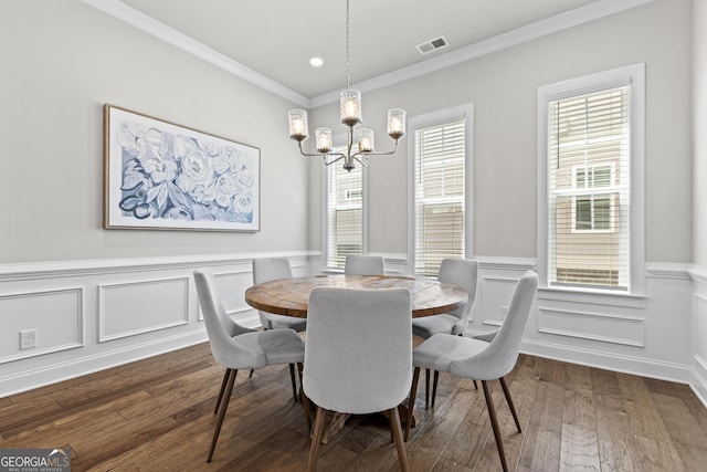 dining space featuring a chandelier, dark wood-style flooring, ornamental molding, wainscoting, and recessed lighting