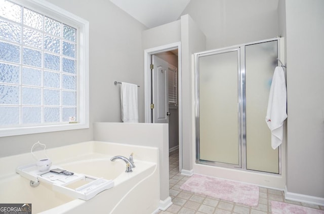 full bath with a shower stall, a garden tub, tile patterned floors, and baseboards