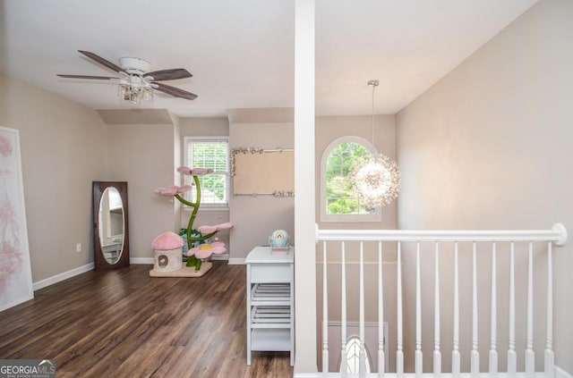 interior space with wood finished floors, baseboards, and a ceiling fan