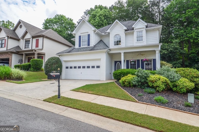 traditional-style house with driveway, a shingled roof, and an attached garage