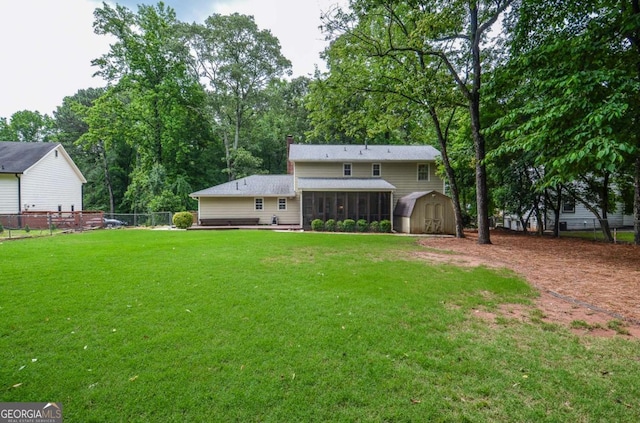 rear view of house featuring a shed, a sunroom, an outbuilding, and a chimney