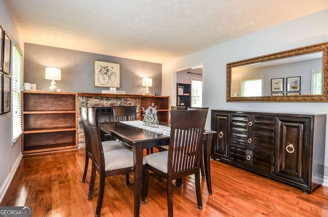 dining room featuring wood finished floors and baseboards