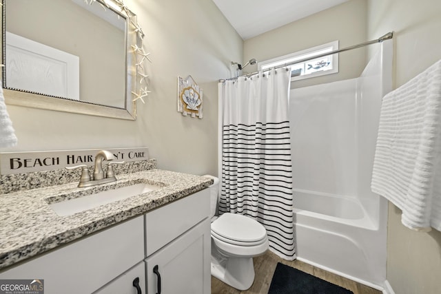 full bath with toilet, shower / bath combination with curtain, vanity, and wood finished floors