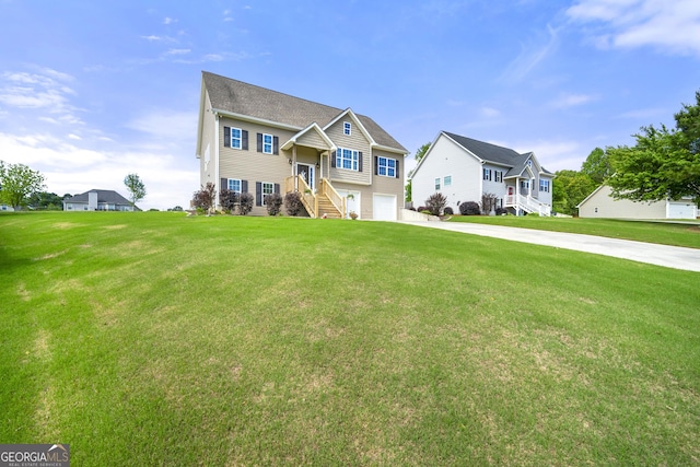 view of front of home featuring a garage, driveway, a residential view, stairs, and a front lawn