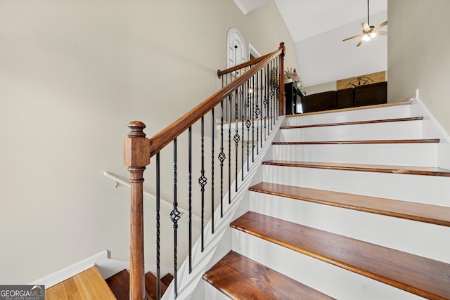 stairs featuring wood finished floors, a ceiling fan, and baseboards