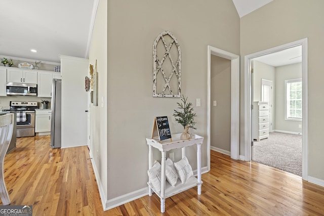 hallway featuring light wood-style floors and baseboards