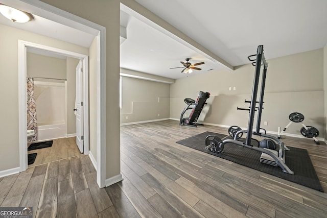exercise room featuring wood finished floors, ceiling fan, and baseboards