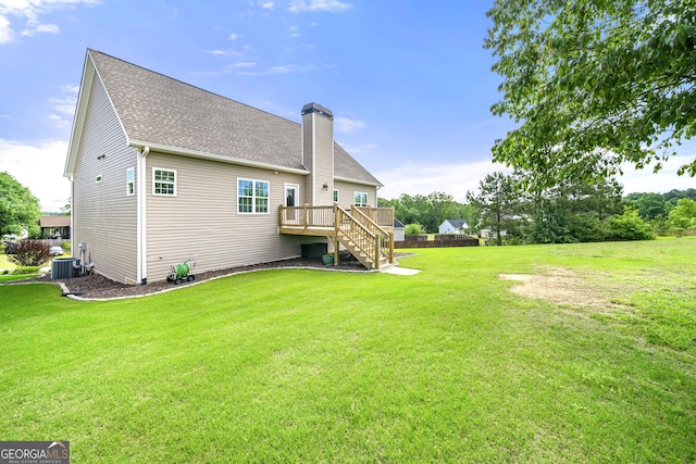 rear view of property featuring stairway, a wooden deck, a chimney, central air condition unit, and a shingled roof