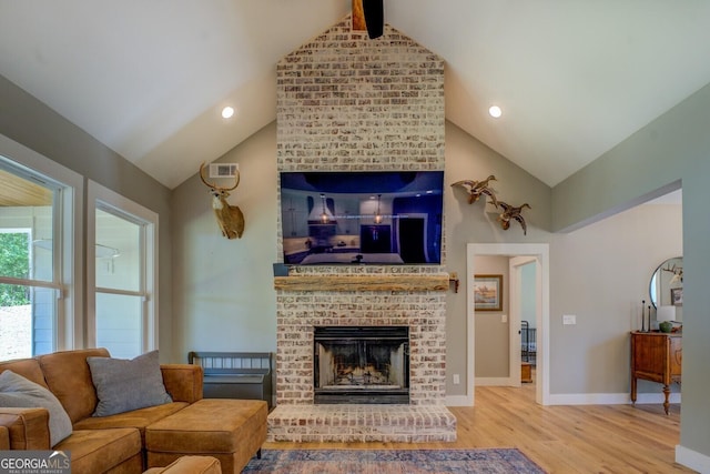 living area featuring wood finished floors, a brick fireplace, beam ceiling, baseboards, and high vaulted ceiling
