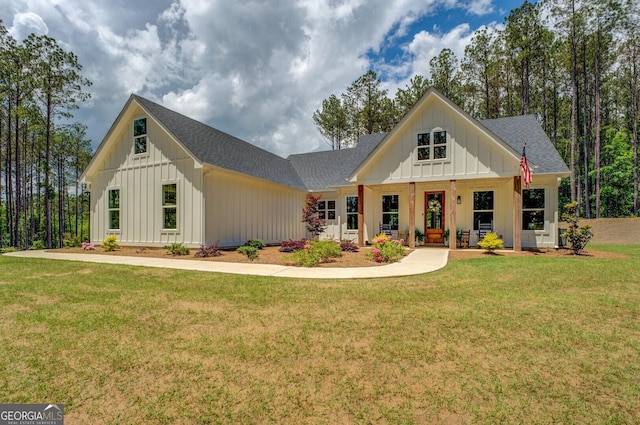 modern farmhouse featuring board and batten siding, roof with shingles, a front lawn, and covered porch