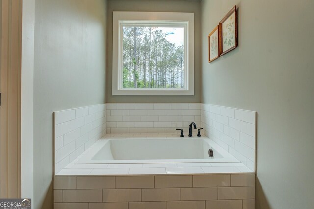 bathroom featuring healthy amount of natural light and a bath