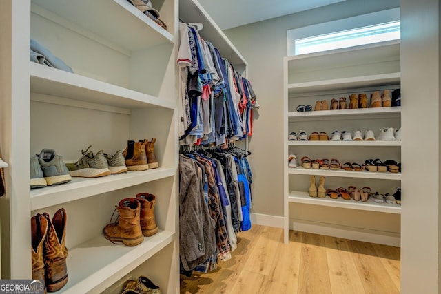 walk in closet with wood finished floors