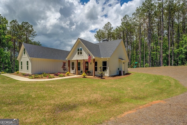 modern farmhouse with a shingled roof, a front lawn, covered porch, and a chimney
