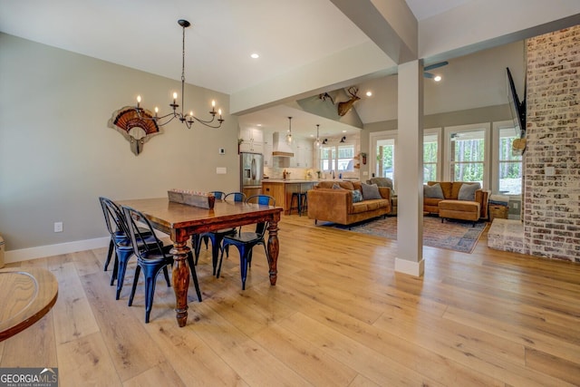 dining room with a chandelier, light wood-type flooring, baseboards, and recessed lighting