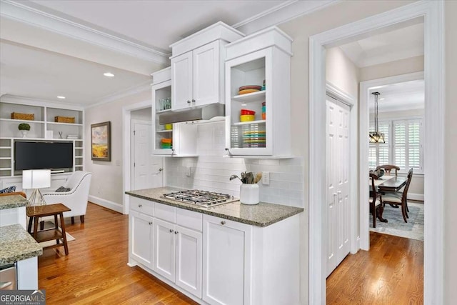66 Mobile Ave NE, Atlanta, GA 30305 - kitchen featuring crown molding, stainless steel gas cooktop, white cabinetry, baseboards, and light wood-type flooring