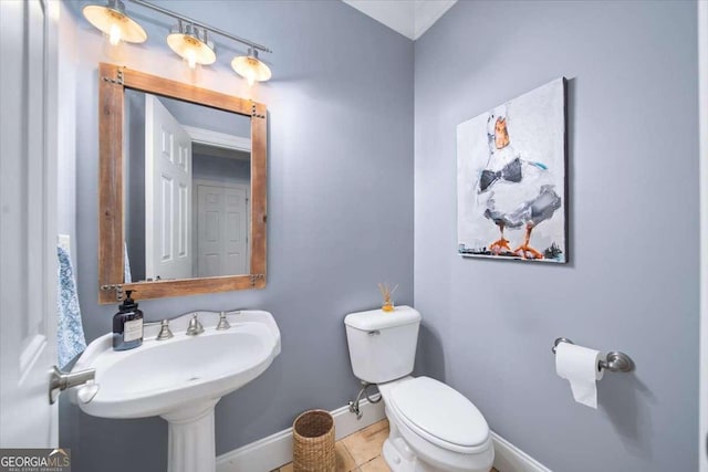 66 Mobile Ave NE, Atlanta, GA 30305 - bathroom featuring baseboards, toilet, and tile patterned floors