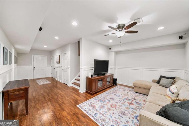66 Mobile Ave NE, Atlanta, GA 30305 - living area with dark wood-type flooring, a ceiling fan, a decorative wall, wainscoting, and stairs
